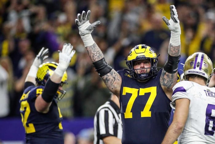 Michigan offensive lineman Trevor Keegan, center, celebrates a touchdown scored.